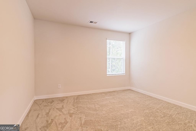 empty room with light colored carpet