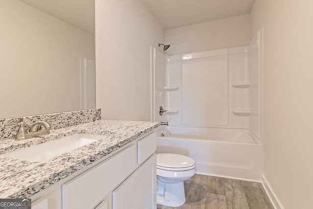 full bathroom with hardwood / wood-style floors, vanity, shower / bathtub combination, and toilet