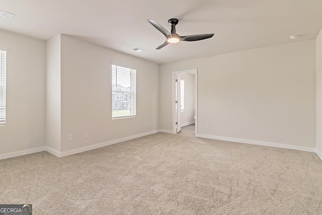 spare room featuring carpet flooring and ceiling fan