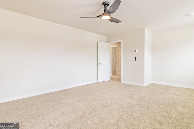 carpeted empty room featuring ceiling fan