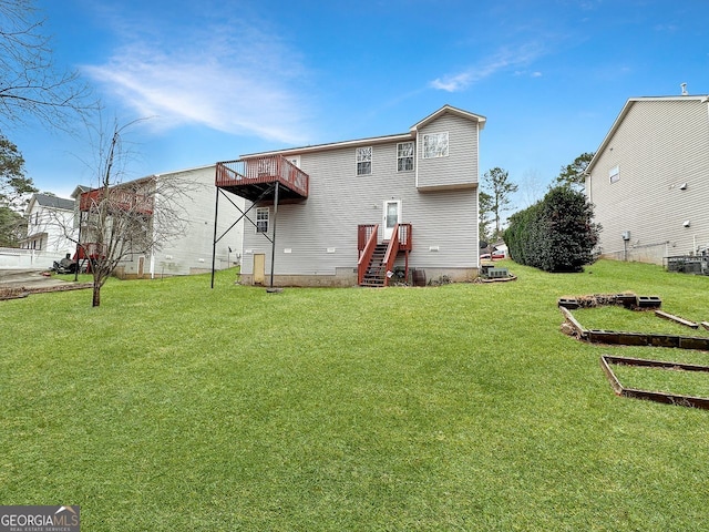 back of house featuring a lawn and a balcony