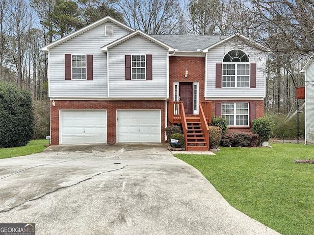 raised ranch featuring a garage and a front yard