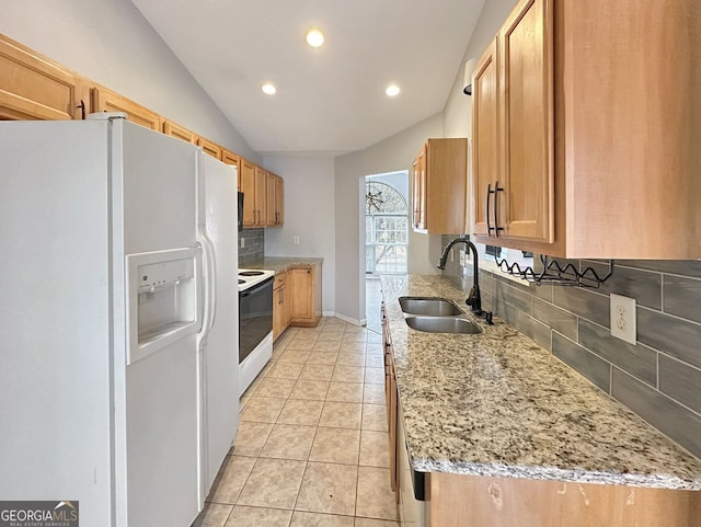 kitchen featuring white appliances, sink, vaulted ceiling, tasteful backsplash, and light stone counters