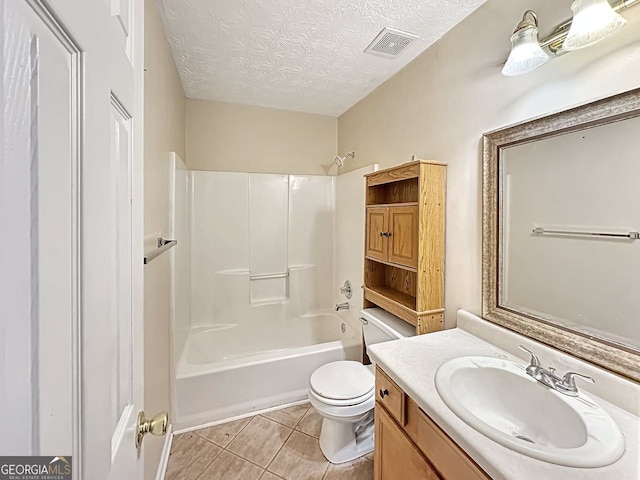 full bathroom featuring tile patterned floors, bathtub / shower combination, vanity, a textured ceiling, and toilet