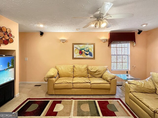 unfurnished living room featuring ceiling fan, a textured ceiling, and light carpet