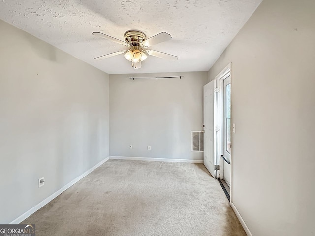 unfurnished room featuring light carpet, a textured ceiling, and ceiling fan