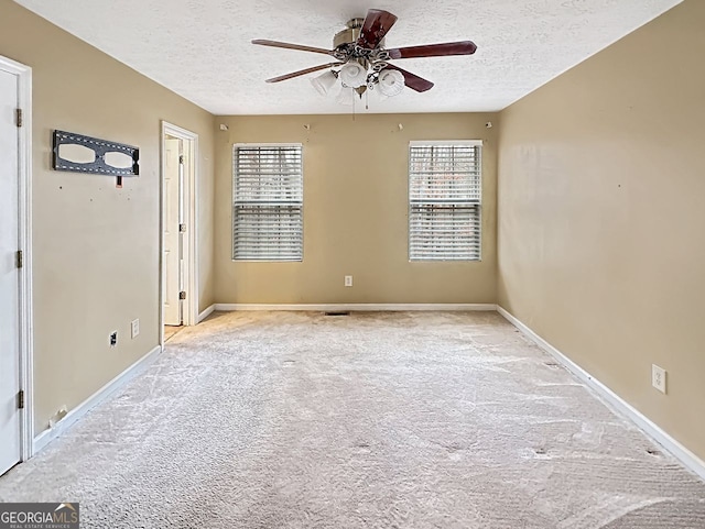 carpeted empty room with a textured ceiling and ceiling fan