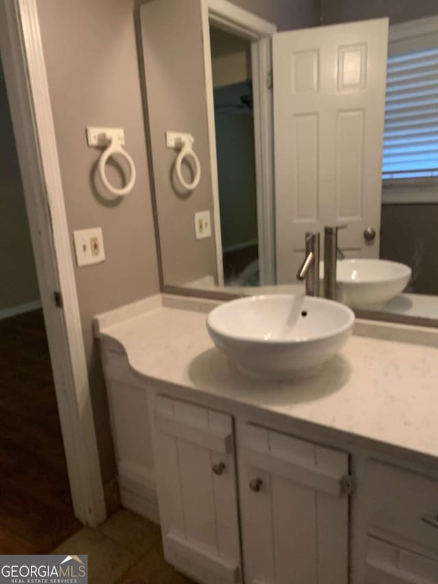 bathroom featuring tile patterned flooring and vanity