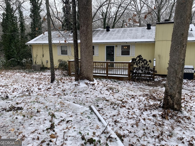 snow covered property featuring central air condition unit