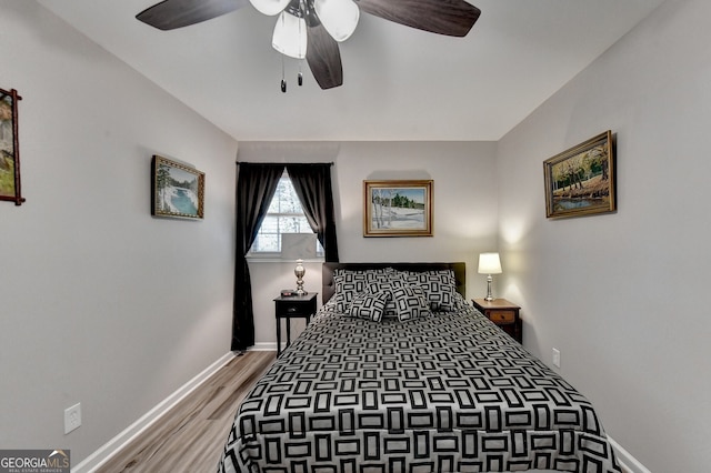 bedroom with hardwood / wood-style floors and ceiling fan