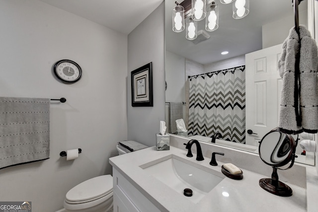 bathroom with a shower with curtain, vanity, and toilet