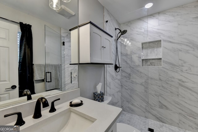 bathroom with vanity, toilet, and a shower with shower door