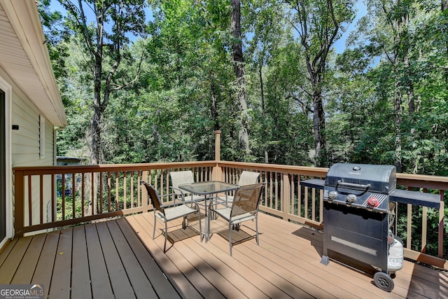 wooden deck featuring a grill