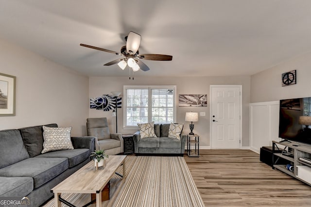 living room featuring hardwood / wood-style flooring and ceiling fan