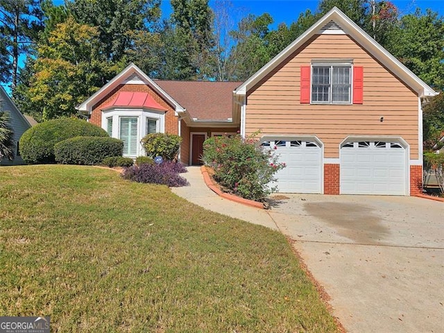 view of property featuring a garage and a front lawn