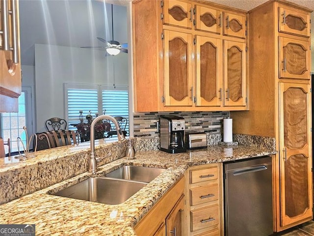 kitchen with appliances with stainless steel finishes, light stone counters, and decorative backsplash