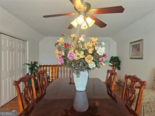 kitchen with stainless steel refrigerator, ceiling fan, a breakfast bar, tasteful backsplash, and kitchen peninsula