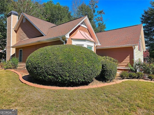 view of property exterior with a lawn