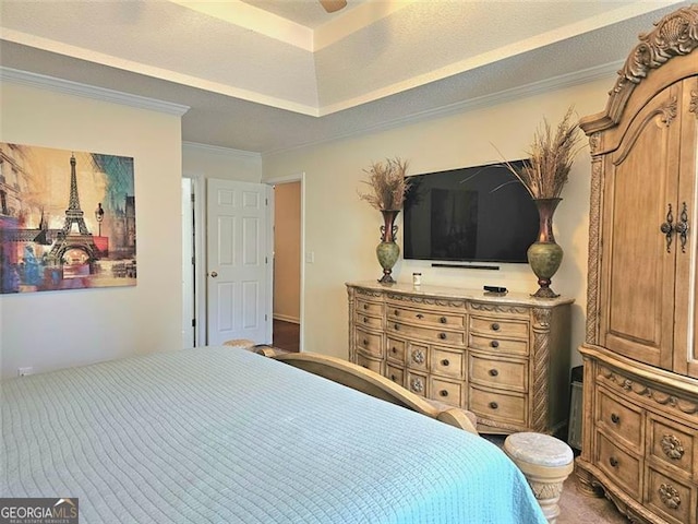 bedroom with ornamental molding, a raised ceiling, and a textured ceiling