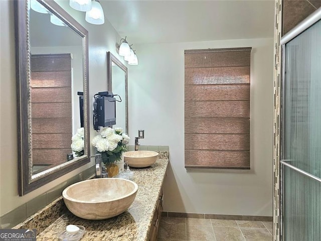 bathroom with tile patterned floors and vanity