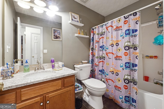 full bathroom with vanity, tile patterned floors, shower / bath combination with curtain, toilet, and a textured ceiling