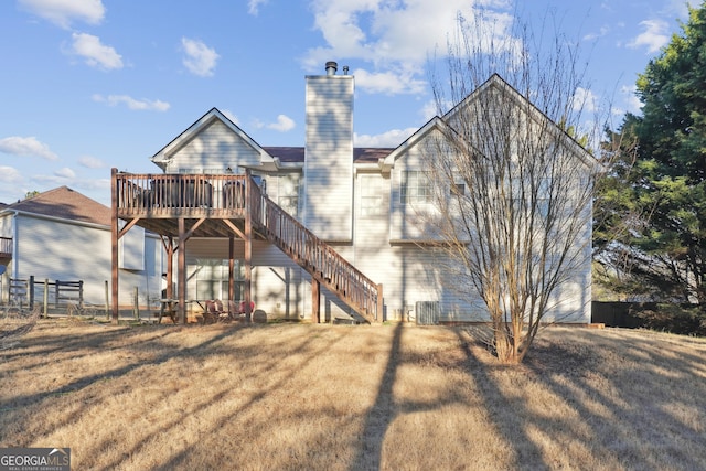 back of house with a yard and a wooden deck