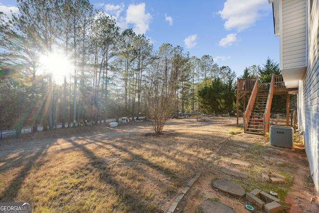 view of yard featuring a deck and central AC