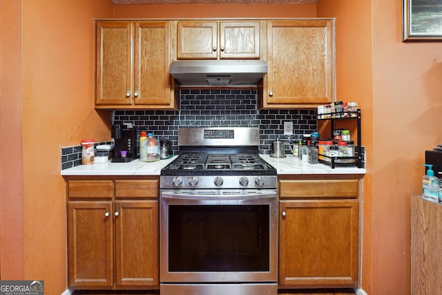 kitchen featuring decorative backsplash and stainless steel range with gas stovetop