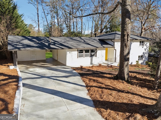 ranch-style home featuring a carport