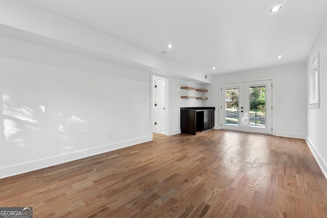 unfurnished living room featuring french doors and wood-type flooring