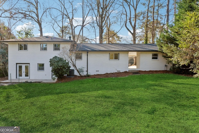 back of house featuring central air condition unit, a yard, and french doors