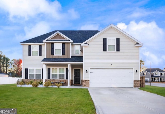 view of front of home with a garage and a front lawn