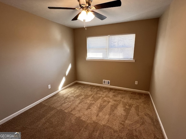 unfurnished room with carpet flooring and ceiling fan