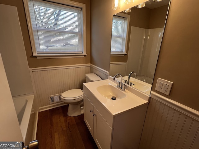 bathroom with vanity, toilet, and wood-type flooring