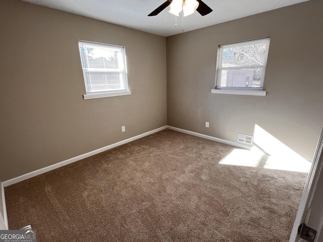 carpeted empty room featuring ceiling fan