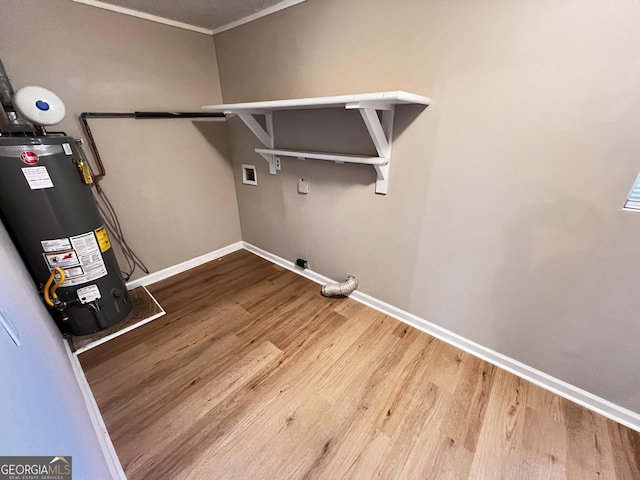 laundry room featuring hardwood / wood-style floors, washer hookup, and gas water heater