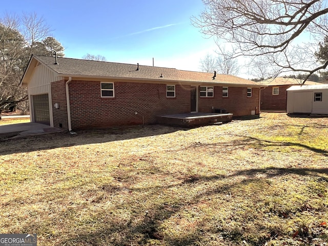 back of property featuring a storage unit and a garage