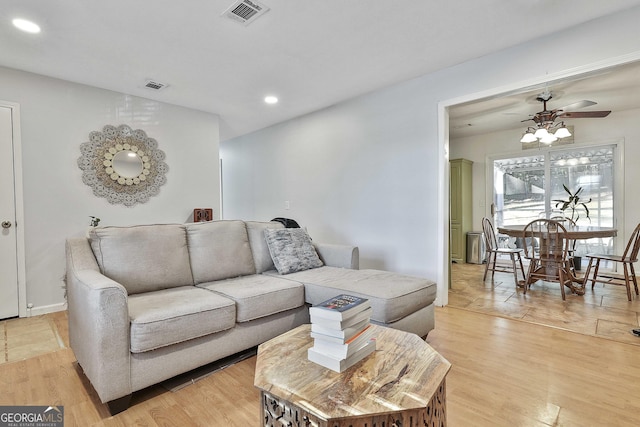 living room with ceiling fan and light wood-type flooring