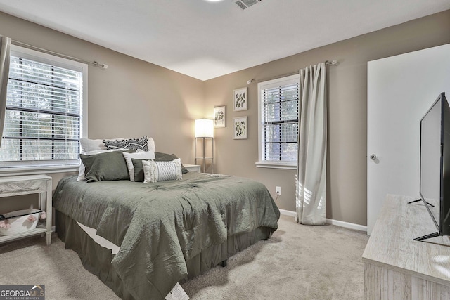 bedroom with carpet and multiple windows