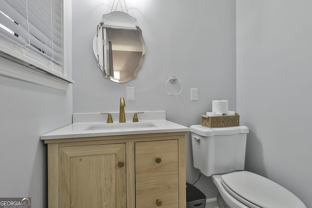 bathroom featuring vanity and toilet