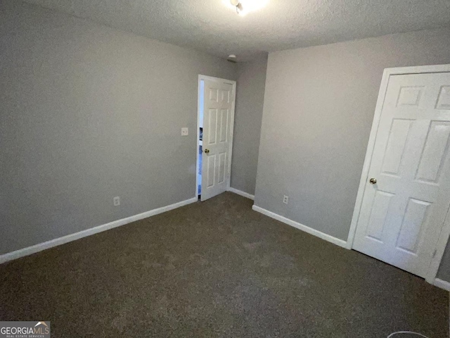 empty room with dark carpet