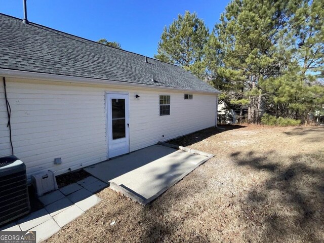 rear view of property featuring a patio area and central AC unit