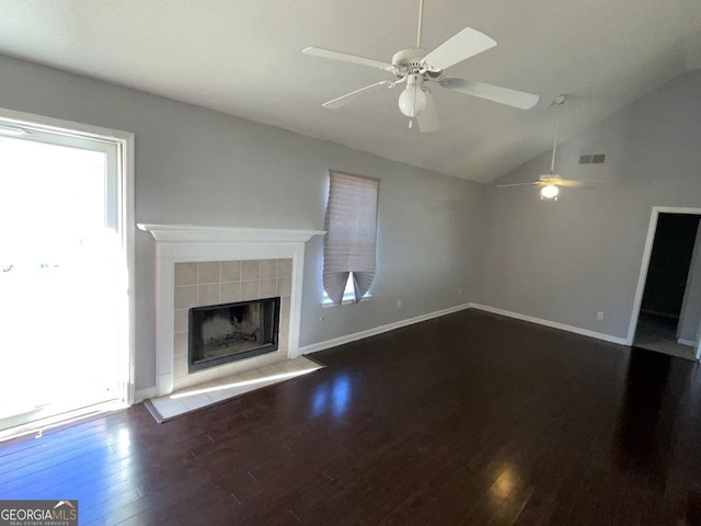 unfurnished living room with ceiling fan, a fireplace, dark hardwood / wood-style floors, and vaulted ceiling