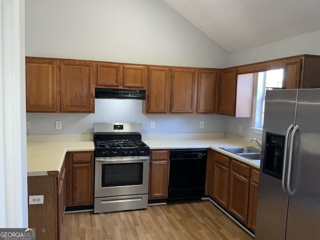 kitchen featuring stainless steel appliances, sink, high vaulted ceiling, and light hardwood / wood-style flooring