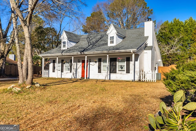 cape cod house featuring a front lawn and covered porch