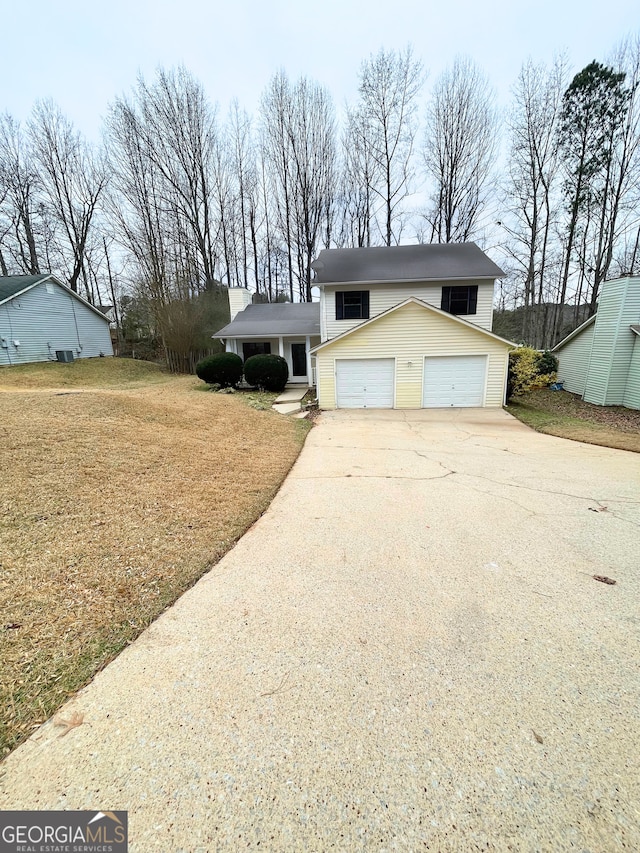 view of front of property featuring a garage and a front lawn