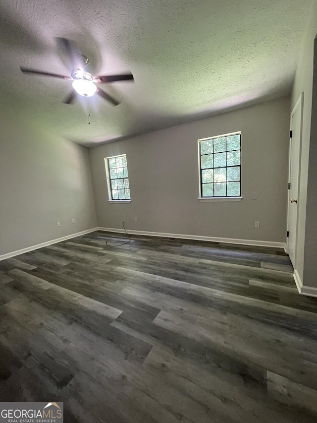 spare room with dark hardwood / wood-style flooring and a textured ceiling