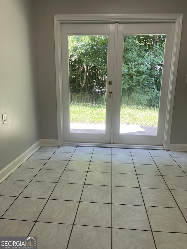 doorway with french doors and light tile patterned flooring