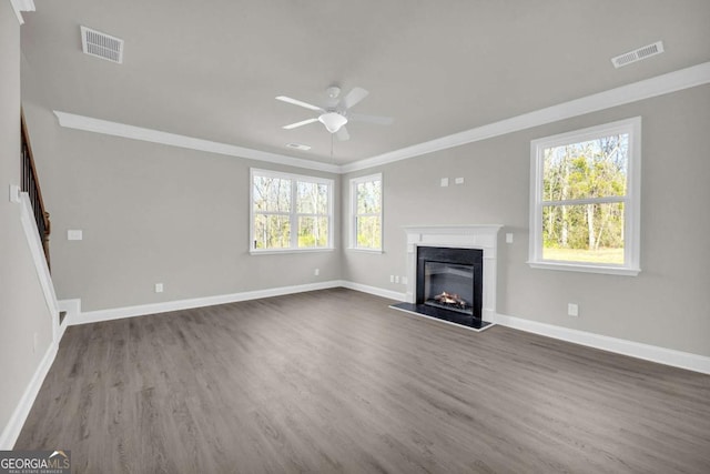 unfurnished living room featuring ceiling fan, dark hardwood / wood-style floors, and ornamental molding