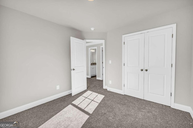 unfurnished bedroom featuring dark colored carpet and a closet